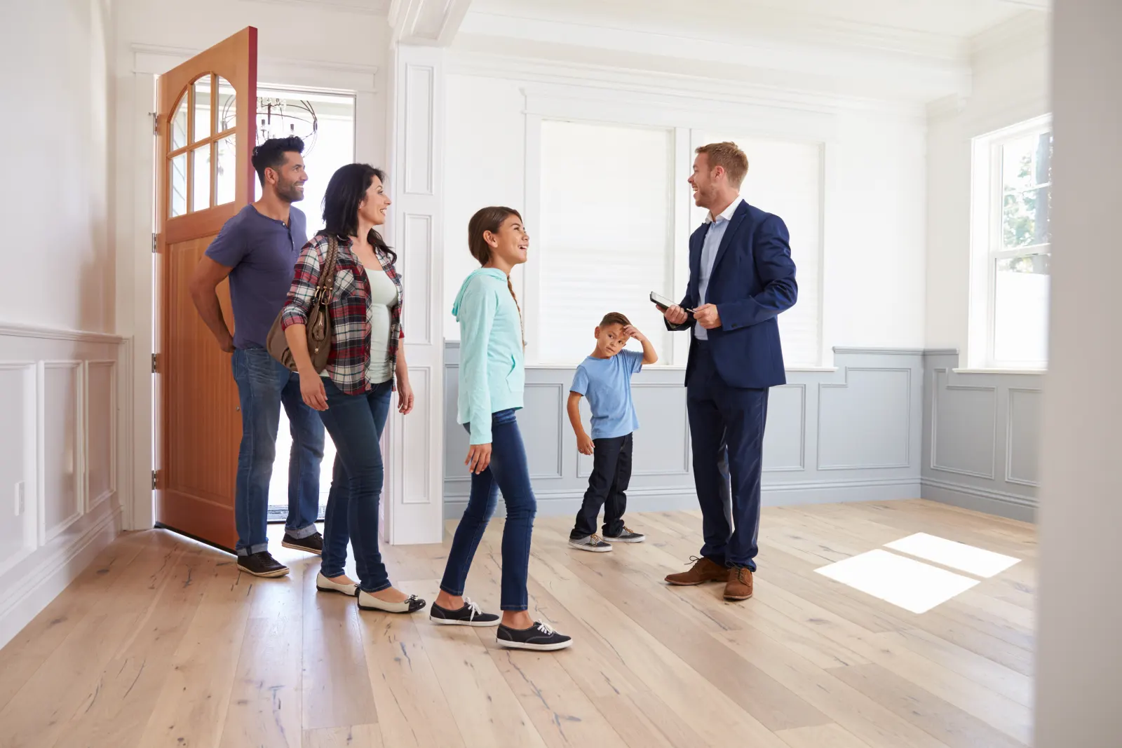 A local real estate agent showing a home to a family in Grand Junction, CO